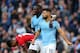MANCHESTER, ENGLAND - NOVEMBER 04: Sergio Aguero of Manchester City celebrates with teammate Benjamin Mendy of Manchester City after assisting Raheem Sterling of Manchester City who scored their team's fourth goal during the Premier League match between Manchester City and Southampton FC at Etihad Stadium on November 4, 2018 in Manchester, United Kingdom. (Photo by Alex Livesey/Getty Images)