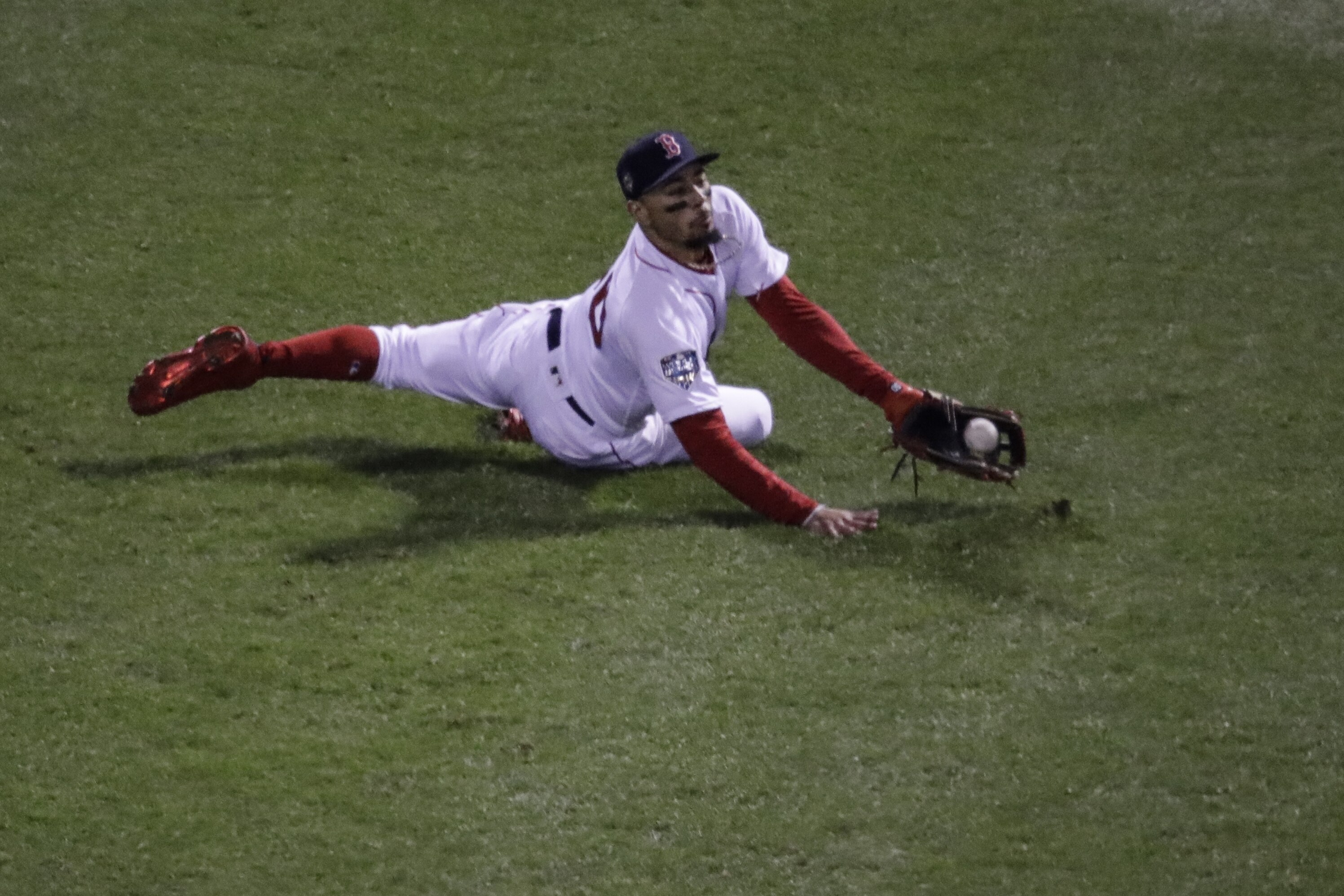 Boston Red Sox's Mookie Betts can't catch a ball hit by Los Angeles Dodgers' David Freese during the fourth inning of Game 2 of the World Series baseball game Wednesday, Oct. 24, 2018, in Boston. (AP Photo/Charles Krupa)