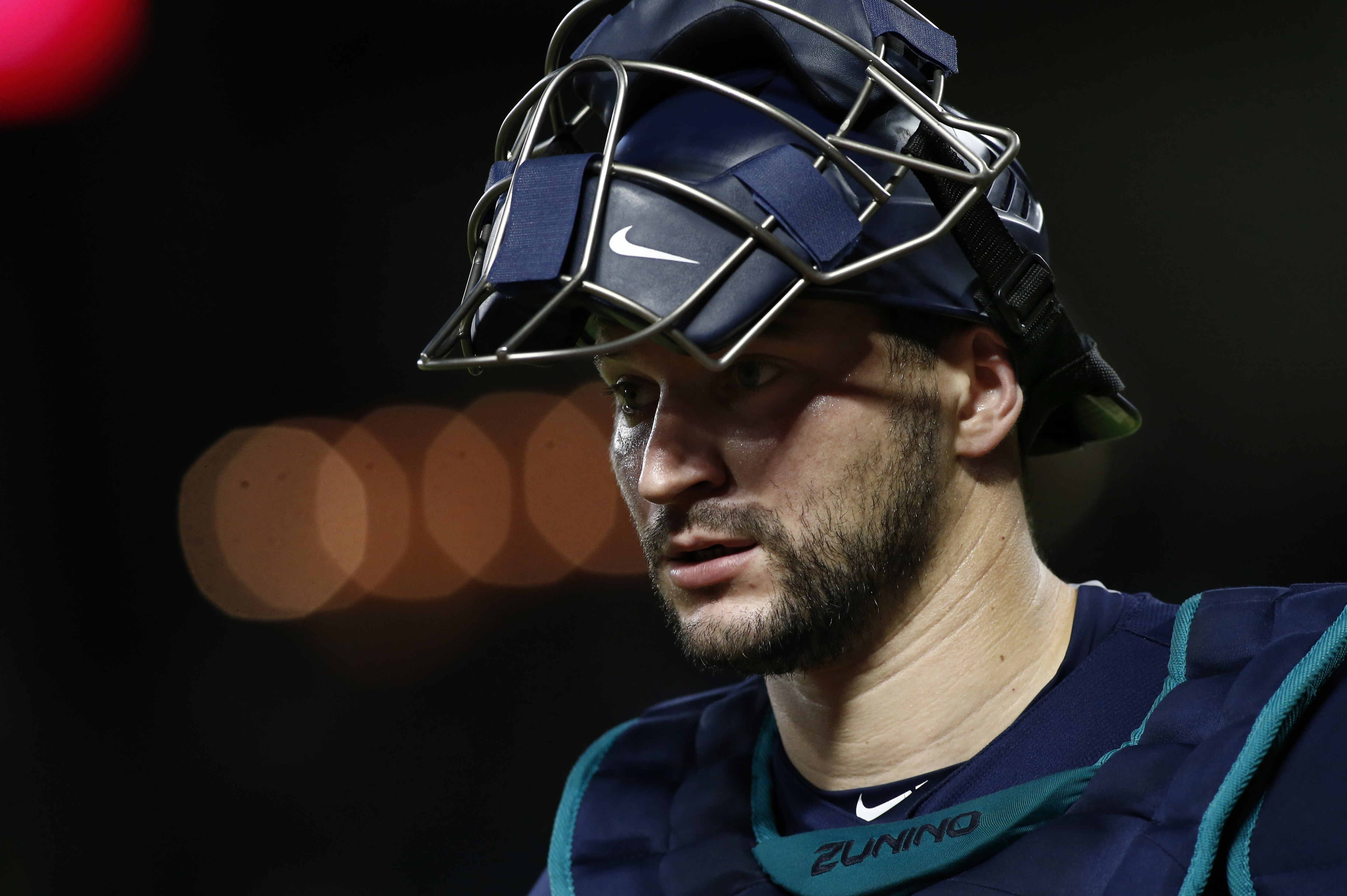 Seattle Mariners catcher Mike Zunino walks towards the dugout against the Texas Rangers after the fifth inning a of a baseball game Friday, Sept. 21, 2018, in Arlington, Texas. (AP Photo/Mike Stone)