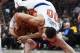 New York Knicks center Enes Kanter tries to hold on to on to the ball as Atlanta Hawks center Miles Plumlee pulls him over his back for a jump ball during the second half of an NBA basketball game Wednesday, Nov. 7, 2018, in Atlanta. New York won 112-107. (AP Photo/John Amis)