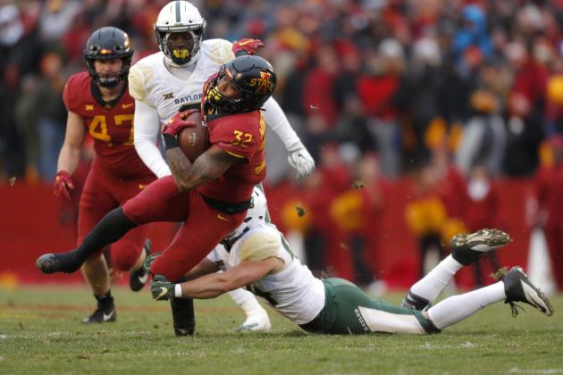 Iowa State running back David Montgomery, front left, runs the ball as he is tackled by Baylor linebacker Clay Johnston, right, during the first half of an NCAA college football game, Saturday, Nov. 10, 2018, in Ames. (AP Photo/Matthew Putney)
