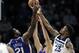 Philadelphia 76ers' Joel Embiid (21), of Cameroon, and Dario Saric (9), of Croatia, go for rebound against Minnesota Timberwolves guard Jimmy Butler (23) during the second quarter of an NBA basketball game on Tuesday, Dec. 12, 2017, in Minneapolis. (AP Photo/Hannah Foslien)