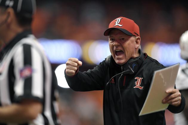 Louisville head coach Bobby Petrino tries to get the referees attention during the first half of an NCAA college football game against Syracuse in Syracuse, N.Y., Friday, Nov. 9, 2018. (AP Photo/Adrian Kraus)