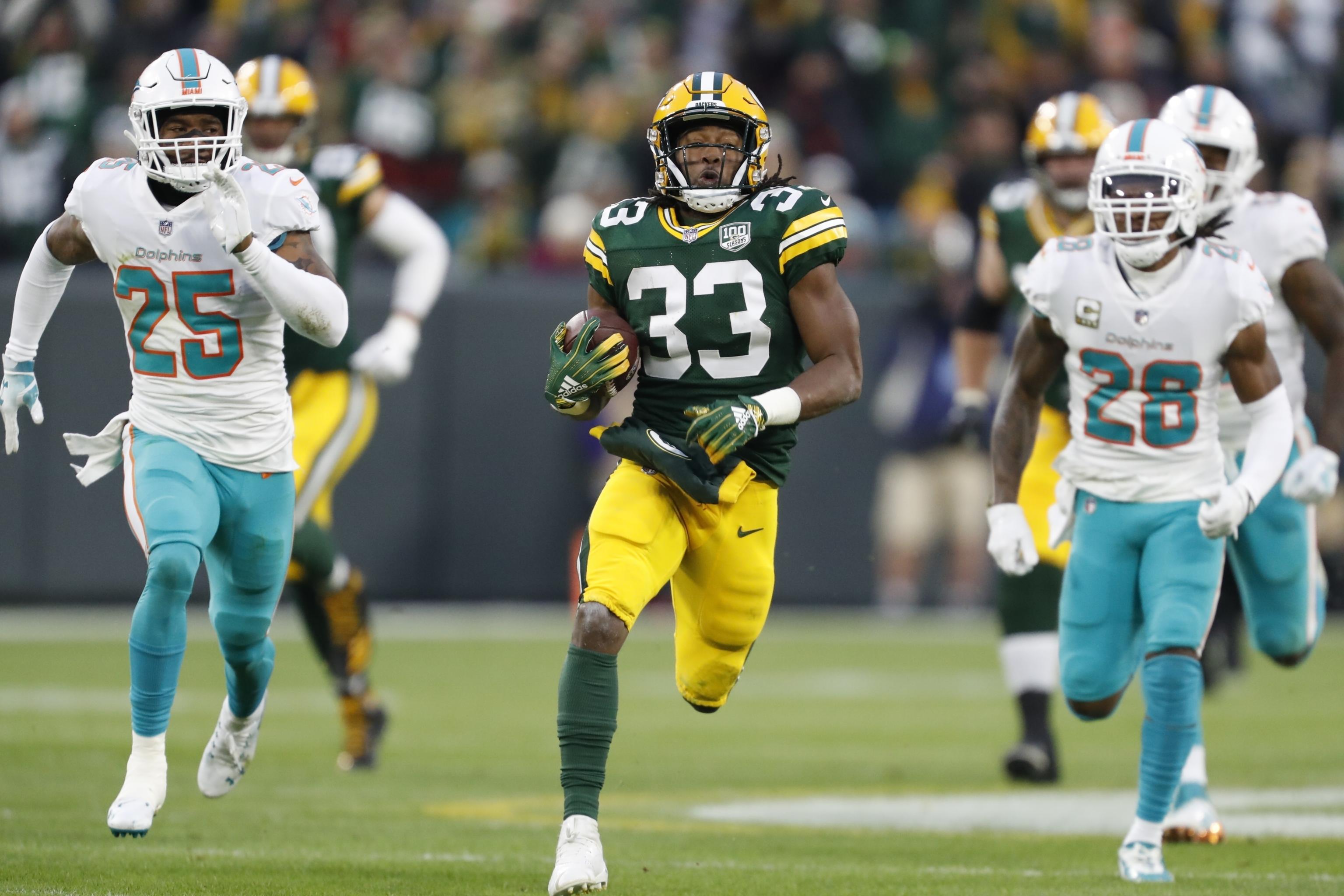 Green Bay Packers' Aaron Jones (33) reaches the end zone for a