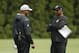 Cincinnati Bengals defensive coordinator Teryl Austin, left, and head coach Marvin Lewis, right, meet on the field during NFL football practice, Monday, July 30, 2018, in Cincinnati. (AP Photo/John Minchillo)