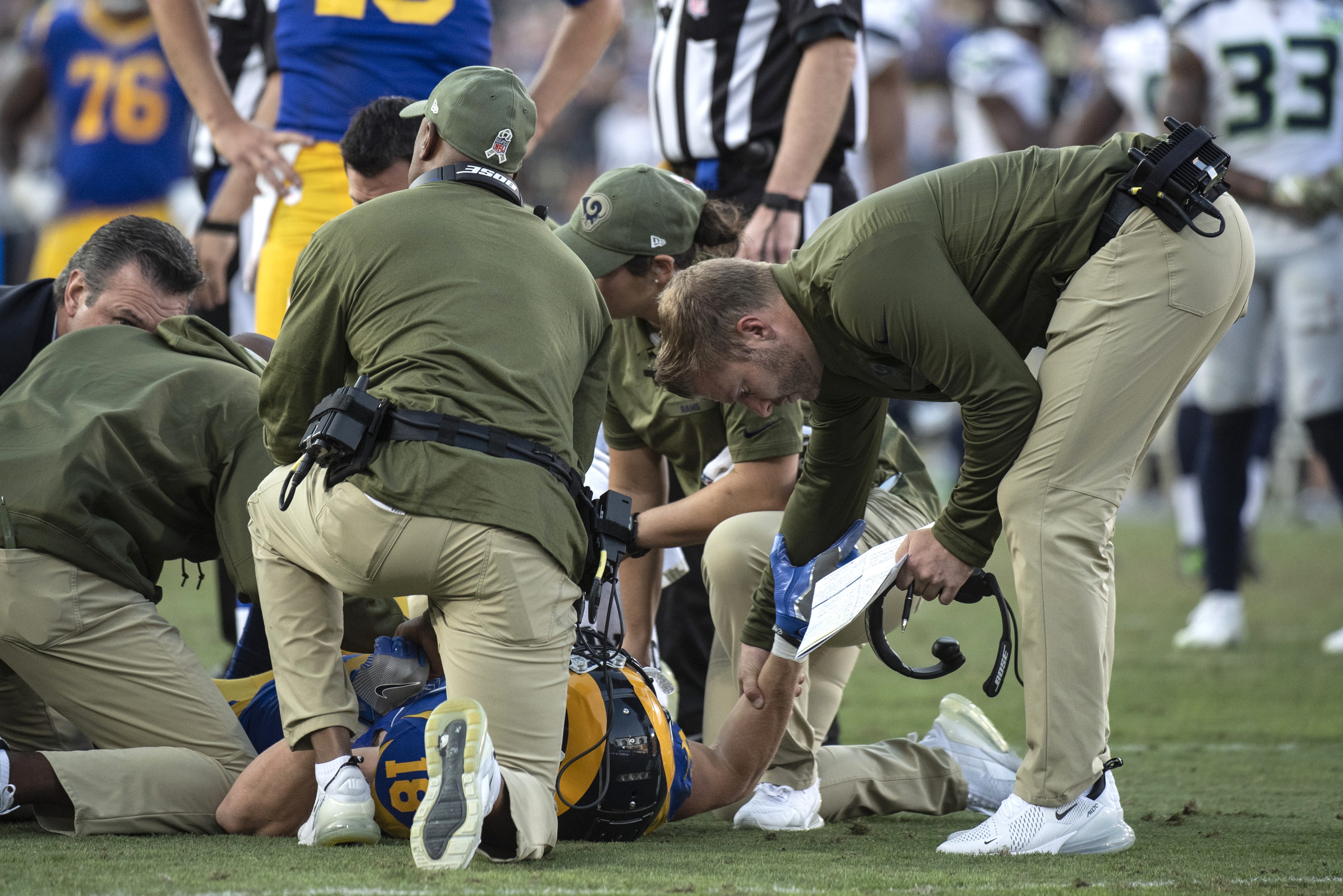 Los Angeles Rams head coach Sean McVay, right, holds a hand of wide receiver Cooper Kupp as he is checked after getting injured during an NFL football game against the Seattle Seahawks Sunday, Nov. 11, 2018, in Los Angeles. (AP Photo/Kyusung Gong)
