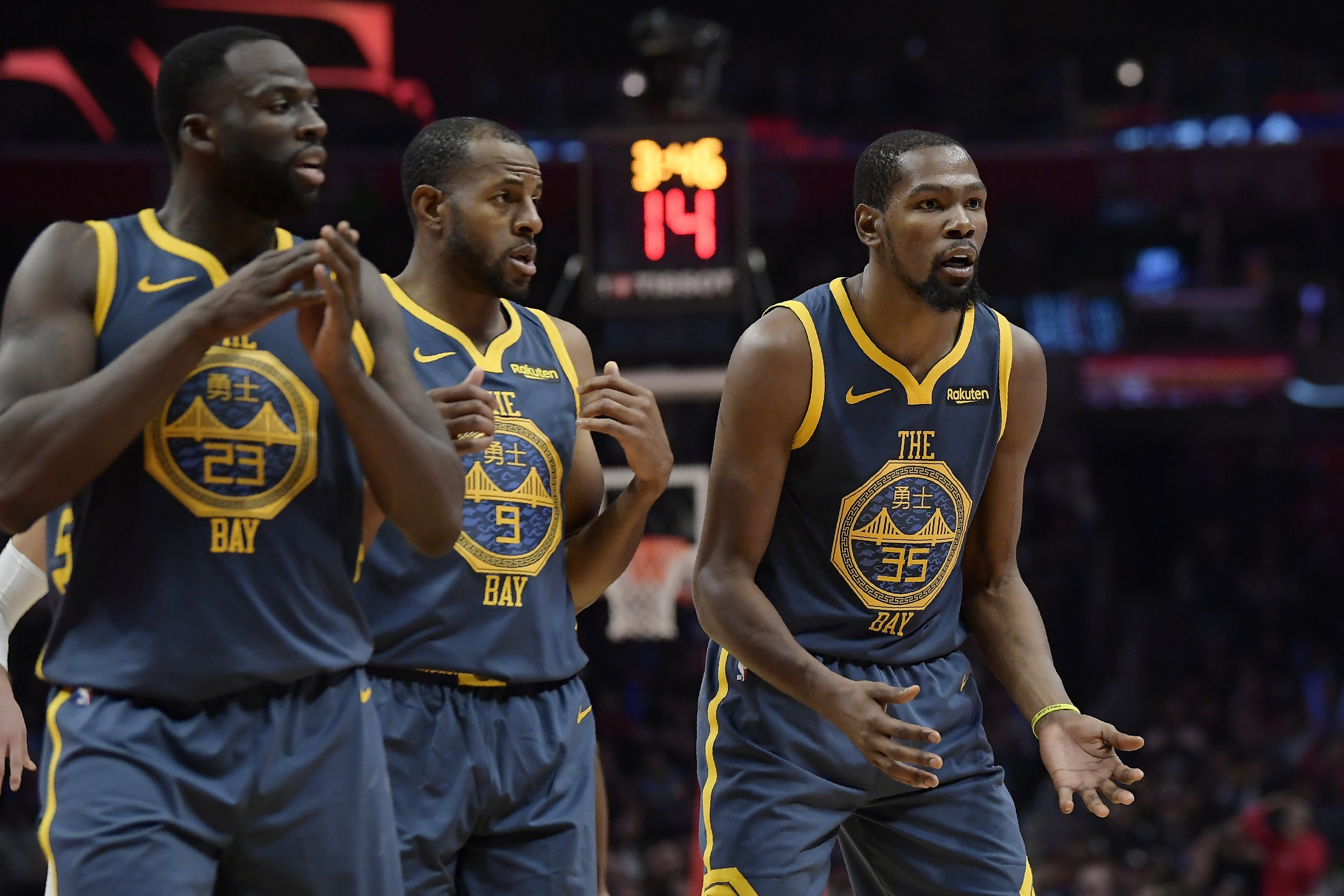 Golden State Warriors forward Kevin Durant, right, reacts as he fouls out of the game while forward Draymond Green, left, and guard Andre Iguodala look on during the overtime portion of an NBA basketball game against the Los Angeles Clippers Monday, Nov. 12, 2018, in Los Angeles. The Clippers won 121-116 in overtime. (AP Photo/Mark J. Terrill)