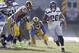 Seattle Seahawks running back Rashaad Penny (20) runs through an opening past Los Angeles Rams nose tackle Ndamukong Suh (93) and defensive tackle Ethan Westbrooks (95), with offensive guard J.R. Sweezy (64) blocking during the first half in an NFL football game Sunday, Nov. 11, 2018, in Los Angeles. (AP Photo/Alex Gallardo)