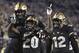 Central Florida defensive back Brandon Moore (20) is congratulated by linebacker Nate Evans, left, and linebacker Eric Mitchell after returning a blocked punt for 60 yards during the first half of an NCAA college football game against Cincinnati Saturday, Nov. 17, 2018, in Orlando, Fla. (AP Photo/Phelan M. Ebenhack)