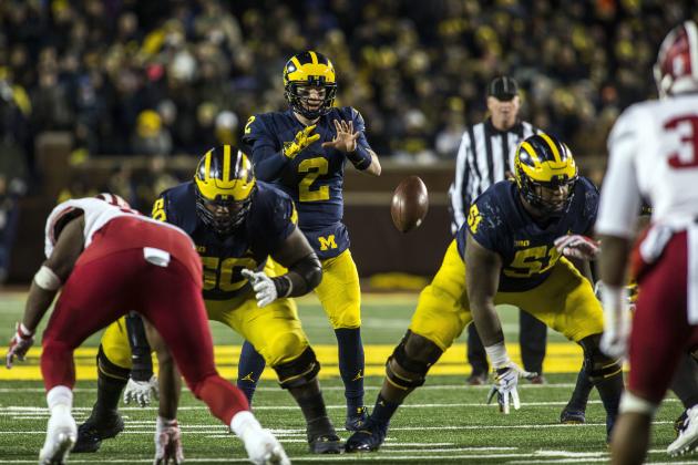 Michigan quarterback Shea Patterson (2) takes a snap from offensive lineman Cesar Ruiz (51) in the fourth quarter of an NCAA college football game in Ann Arbor, Mich., Saturday, Nov. 17, 2018. Michigan won 31-20. (AP Photo/Tony Ding)