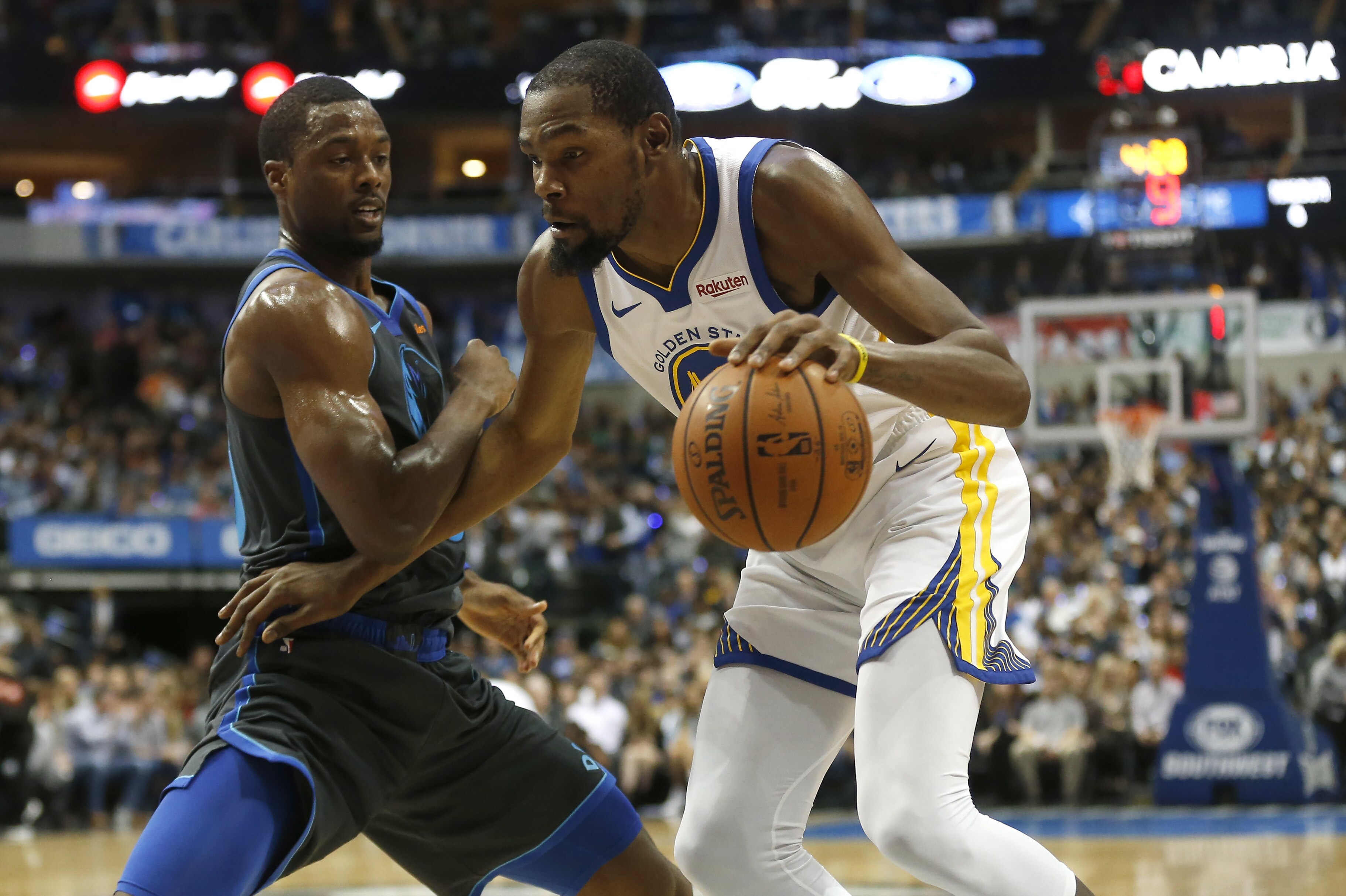 Golden State Warriors forward Kevin Durant (35) drives as Dallas Mavericks forward Harrison Barnes (40) defends during the first half of an NBA basketball game, Saturday, Nov. 17, 2018, in Dallas. (AP Photo/Ron Jenkins)