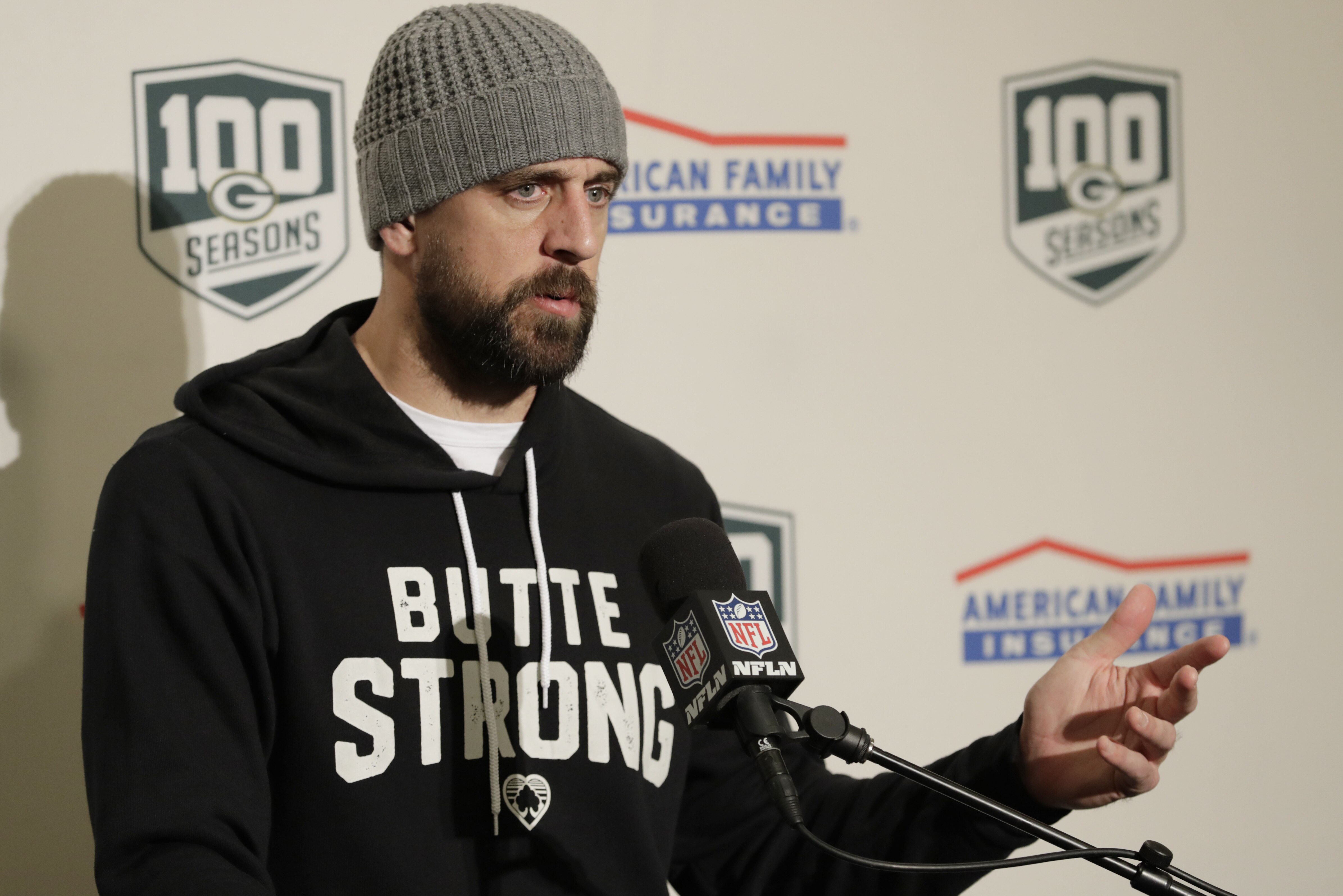 Green Bay Packers quarterback Aaron Rodgers wears a sweatshirt that reads