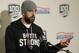 Green Bay Packers quarterback Aaron Rodgers wears a sweatshirt that reads