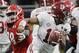 Alabama's Tua Tagovailoa scrambles from Georgia's Trenton Thompson during the second half of the NCAA college football playoff championship game Monday, Jan. 8, 2018, in Atlanta. (AP Photo/David J. Phillip)