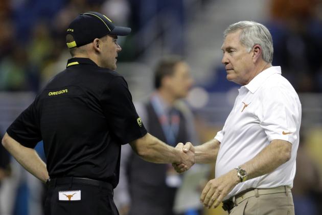 Oregon coach Mark Helfrich, left, shakes hands with Texas coach Mack Brown, right, before the Valero Alamo Bowl NCAA college football game, Monday, Dec. 30, 2013, in San Antonio. (AP Photo/Eric Gay)