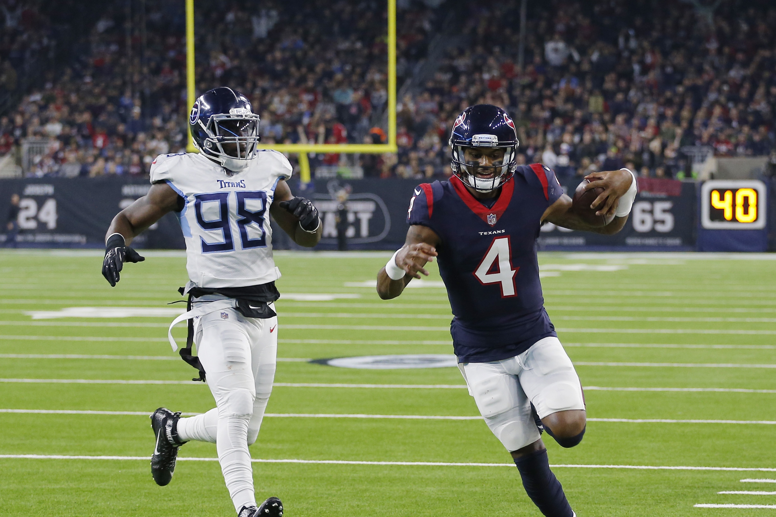 HOUSTON, TEXAS - NOVEMBER 26: Deshaun Watson #4 of the Houston Texans runs for a 15 yard touchdown as he beats Brian Orakpo #98 of the Tennessee Titans to the endzone during the second quarter against the Tennessee Titans at NRG Stadium on November 26, 2018 in Houston, Texas. (Photo by Bob Levey/Getty Images)