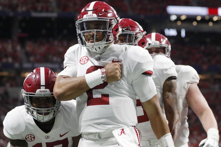 Alabama Crimson Tide quarterback Tua Tagovailoa (13) hands off to Alabama  Crimson Tide running back Josh Jacobs (8) in the fourth quarter during the  college football playoff semifinal at the Capital One