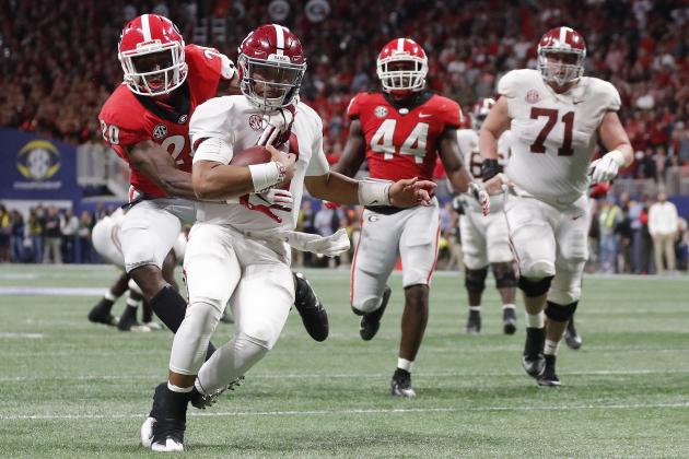 Georgia defensive back J.R. Reed (20) tries to tackle Alabama quarterback Jalen Hurts (2) during the second half of the Southeastern Conference championship NCAA college football game, Saturday, Dec. 1, 2018, in Atlanta. Hurts scored a touchdown on the play. (AP Photo/John Bazemore)