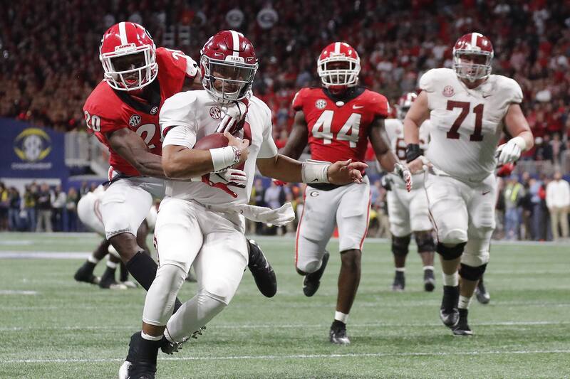 Georgia defensive back J.R. Reed (20) tries to tackle Alabama quarterback Jalen Hurts (2) during the second half of the Southeastern Conference championship NCAA college football game, Saturday, Dec. 1, 2018, in Atlanta. Hurts scored a touchdown on the play. (AP Photo/John Bazemore)