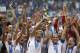 FILE - In this July 5, 2015, file photo, the United States Women's National Team celebrates with the trophy after they beat Japan 5-2 in the FIFA Women's World Cup soccer championship in Vancouver, British Columbia, Canada. Five players from the World Cup-winning U.S. national team have accused the U.S. Soccer Federation of wage discrimination in an action filed with the Equal Employment Opportunity Commission. Alex Morgan, Carli Lloyd, Megan Rapinoe, Becky Sauerbrunn and Hope Solo maintain in the EEOC filing they were paid nearly four times less than their male counterparts on the U.S. men's national team. The filing was announced Thursday in a statement from the law firm representing the players. (AP Photo/Elaine Thompson, File)