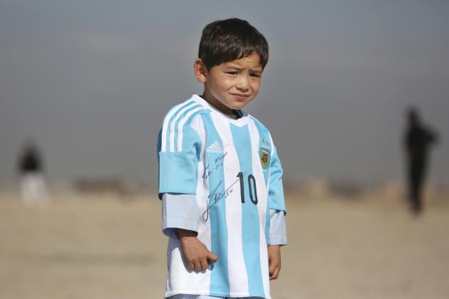 Murtaza Ahmadi, a five-year-old Afghan Lionel Messi fan poses for a portrait in a shirt signed by Messi, in Kabul, Afghanistan, Friday, Feb. 26, 2016.  Mohammad Arif Ahmadi, the father of the boy who was pictured wearing a homemade Argentina shirt with No. 10 on the back, said Friday they want to thank Messi, a UNICEF goodwill ambassador, in person.(AP Photo/Rahmat Gul)