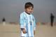 Murtaza Ahmadi, a five-year-old Afghan Lionel Messi fan poses for a portrait in a shirt signed by Messi, in Kabul, Afghanistan, Friday, Feb. 26, 2016. Mohammad Arif Ahmadi, the father of the boy who was pictured wearing a homemade Argentina shirt with No. 10 on the back, said Friday they want to thank Messi, a UNICEF goodwill ambassador, in person.(AP Photo/Rahmat Gul)