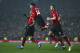 Manchester United's midfielder Jesse Lingard, center, jumps on the shoulders of teammate Anthony Martial who scored his side's first goal during the English Premier League soccer match between Manchester United and Arsenal at Old Trafford stadium in Manchester, England, Wednesday Dec. 5, 2018. (AP Photo/Dave Thompson)