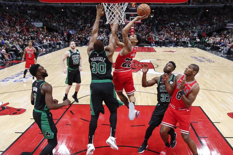 Chicago Bulls guard Cameron Payne (22) shoots against Boston Celtics forward Guerschon Yabusele (30) during the second half of an NBA basketball game, Saturday, Dec. 8, 2018, in Chicago. (AP Photo/Kamil Krzaczynski)