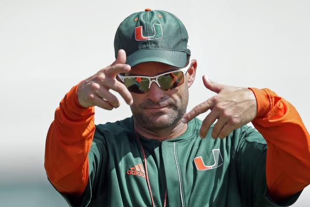 Miami defensive coordinator Manny Diaz, left, gives instructions to the players during drills at football practice, Thursday, Aug. 4, 2016, in Coral Gables, Fla. (AP Photo/Alan Diaz)