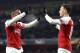 Arsenal's Alexandre Lacazette, left, and Arsenal's Mesut Ozil celebrate after scoring their side's first goal during the Europa League group E soccer match between Arsenal and Qarabag at Emirates stadium in London, England, Thursday, Dec. 13, 2018. (AP Photo/Frank Augstein)