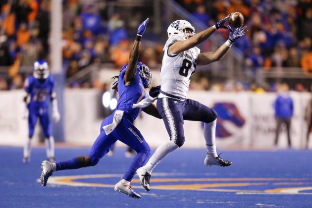 Utah State tight end Dax Raymond (87) reaches up to catch the ball as Boise State cornerback Tyler Horton (14) makes a tackle attempt in the second half of an NCAA college football game, Saturday, Nov. 24, 2018, in Boise, Idaho. Boise State won 33-24. (AP Photo/Steve Conner)