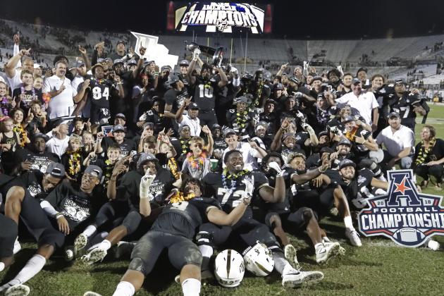 Central Florida players, coaches and family members celebrate after defeating Memphis in the American Athletic Conference championship NCAA college football game, Saturday, Dec. 1, 2018, in Orlando, Fla. (AP Photo/John Raoux)