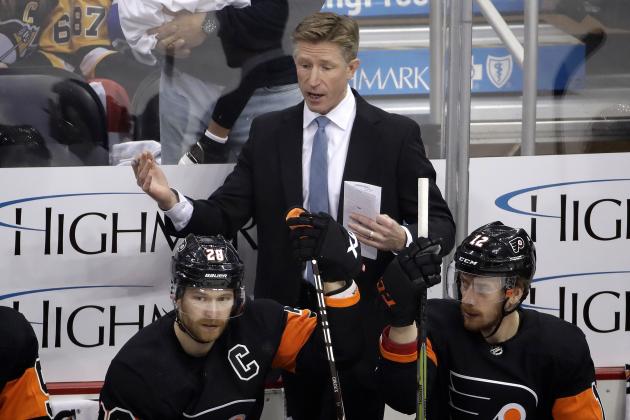 Philadelphia Flyers head coach Dave Hakstol talks with Claude Giroux (28) during the first period of an NHL hockey game against the Pittsburgh Penguins in Pittsburgh, Saturday, Dec. 1, 2018. The Flyers won 4-2. (AP Photo/Gene J. Puskar)
