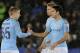 Manchester City's Oleksandr Zinchenko, left and teammate Manchester City's Eric Garcia shakes hands just prior to kick off for the English League Cup quarterfinal soccer match at the King Power stadium in Leicester, England, Tuesday, Dec.18, 2018. (AP Photo/Rui Vieira)