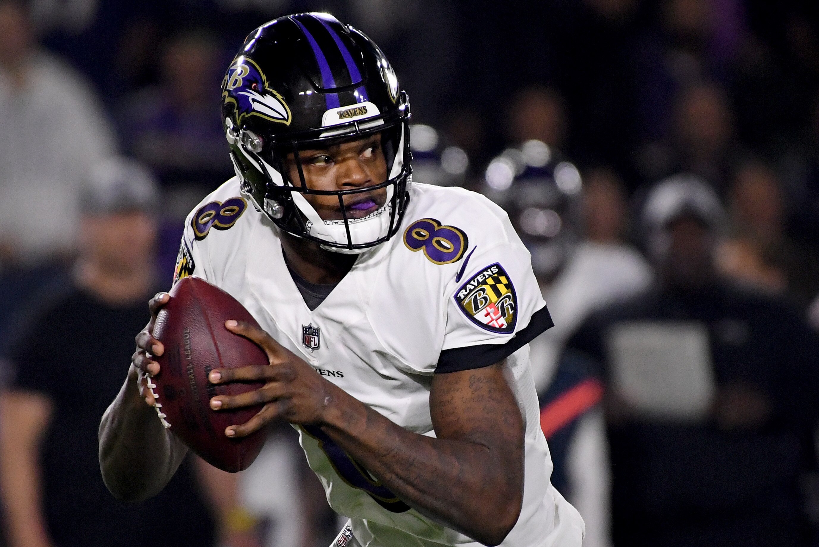 CARSON, CALIFORNIA - DECEMBER 22:   Lamar Jackson #8 of the Baltimore Ravens rolls out of the pocket during the second quarter against the Los Angeles Chargers at StubHub Center on December 22, 2018 in Carson, California. (Photo by Harry How/Getty Images)