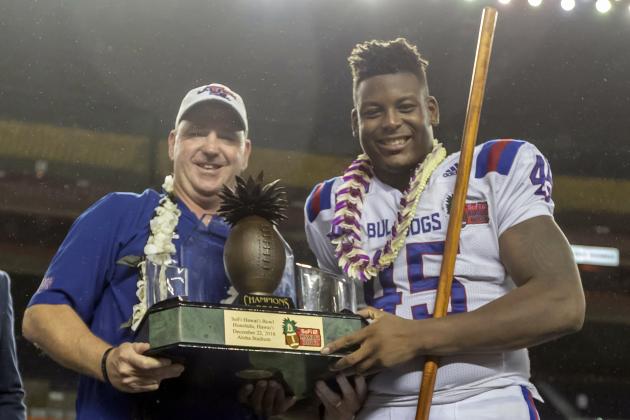 Louisiana Tech head coach Skip Holtz and Louisiana Tech defensive end Jaylon Ferguson (45) hold the Hawaii Bowl Championship trophy after a Hawaii Bowl NCAA college football game against Hawaii, Saturday, Dec. 22, 2018, in Honolulu. Louisiana Tech beat Hawaii 31-14. (AP Photo/Eugene Tanner)