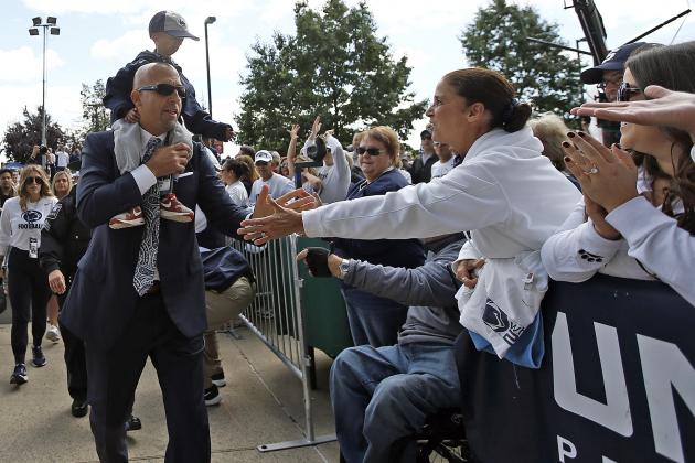Penn State head coach James Franklin, carrying fan Josiah Viera, 13, greet fans as the team arrives at the stadium to take on Pittsburgh in an NCAA college football game in State College, Pa., Saturday, Sept. 9, 2017. Josiah, suffers from a genetic disease called Progeria, meaning