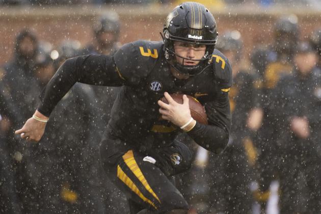 Missouri quarterback Drew Lock runs with the ball during the first half of an NCAA college football game against Arkansas Friday, Nov. 23, 2018, in Columbia, Mo. (AP Photo/L.G. Patterson)