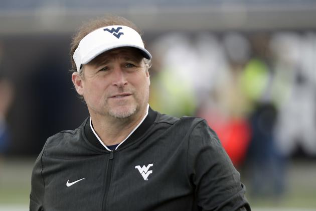 West Virginia head coach Dana Holgorsen walks on the field before the first half of the Camping World Bowl NCAA college football game against Syracuse, Friday, Dec. 28, 2018, in Orlando, Fla. (AP Photo/John Raoux)