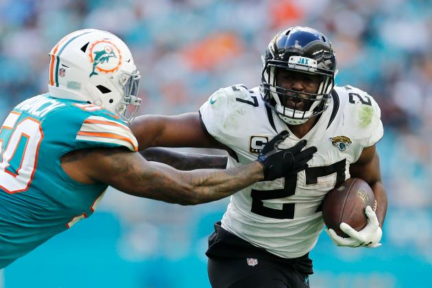 MIAMI, FL - DECEMBER 23: Leonard Fournette #27 of the Jacksonville Jaguars breaks a tackle from Andre Branch #50 of the Miami Dolphins at Hard Rock Stadium on December 23, 2018 in Miami, Florida. (Photo by Michael Reaves/Getty Images)