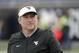 West Virginia head coach Dana Holgorsen walks on the field before the first half of the Camping World Bowl NCAA college football game against Syracuse, Friday, Dec. 28, 2018, in Orlando, Fla. (AP Photo/John Raoux)