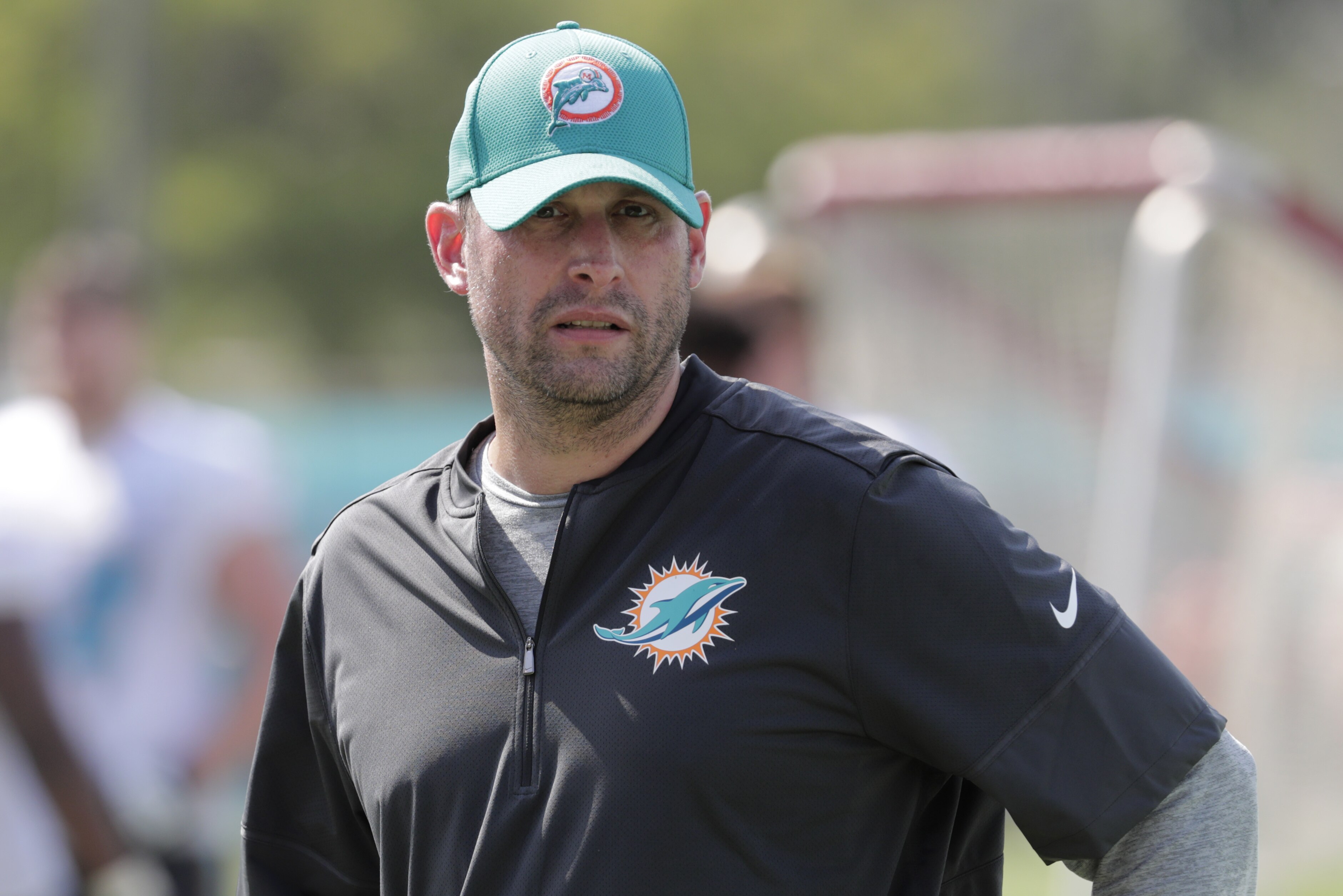Miami Dolphins head coach Adam Gase walks on the field at the NFL football team's training camp, Thursday, July 26, 2018, in Davie, Fla. (AP Photo/Lynne Sladky)