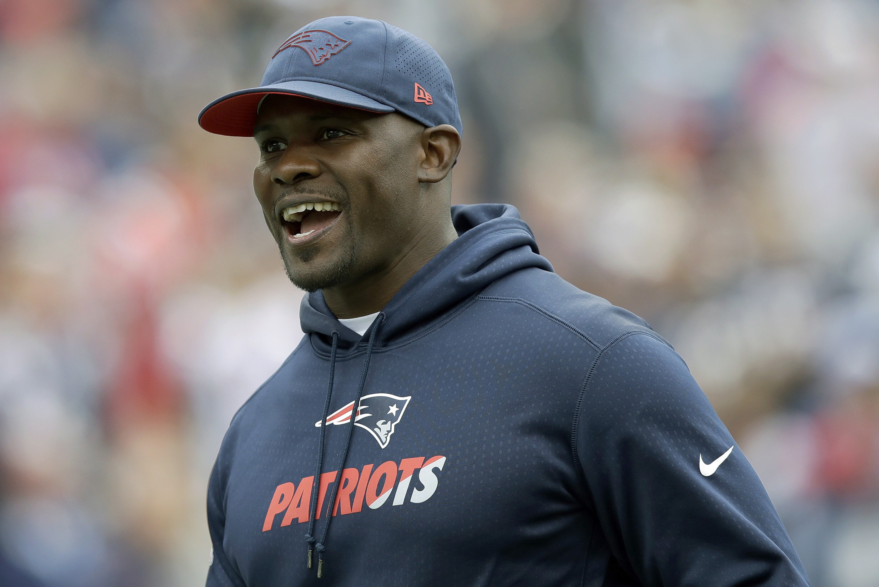 New England Patriots linebackers coach Brian Flores watches his team warm up before an NFL football game against the Houston Texans, Sunday, Sept. 9, 2018, in Foxborough, Mass. (AP Photo/Charles Krupa)