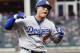 Los Angeles Dodgers' Manny Machado (8) celebrates his three-run homer against the Atlanta Braves during the seventh inning in Game 4 of baseball's National League Division Series, Monday, Oct. 8, 2018, in Atlanta. (AP Photo/John Bazemore)