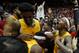 New Mexico guard Keith McGee (3) and forward Corey Manigault, left, celebrate with fans after the team's 85-58 victory over Nevada in an NCAA college basketball game in Albuquerque, N.M., Saturday, Jan. 5, 2019. (AP Photo/Andres Leighton)