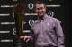 Clemson head coach Dabo Swinney poses with the championship trophy at a news conference for the NCAA college football playoff championship game Tuesday, Jan. 8, 2019, in San Jose, Calif. (AP Photo/David J. Phillip)
