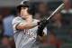 Miami Marlins' J.T. Realmuto follows through on two-run base hit in the fourth inning of a baseball game against the Atlanta Braves Tuesday, Aug. 14, 2018 in Atlanta. (AP Photo/John Bazemore)