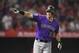Colorado Rockies' DJ LeMahieu gestures toward his dugout as he runs to first after hitting a grand slam during the eighth inning of a baseball game against the Los Angeles Angels, Monday, Aug. 27, 2018, in Anaheim, Calif. (AP Photo/Mark J. Terrill)