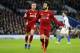 BRIGHTON, ENGLAND - JANUARY 12: Mohamed Salah of Liverpool celebrates with team mate Jordan Henderason of Liverpool after scoring their first goal from the penalty spot during the Premier League match between Brighton & Hove Albion and Liverpool FC at American Express Community Stadium on January 12, 2019 in Brighton, United Kingdom. (Photo by Bryn Lennon/Getty Images)