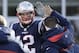 New England Patriots offensive coordinator Josh McDaniels, right, gives a high-five to quarterback Tom Brady during the first half of an NFL divisional playoff football game against the Los Angeles Chargers, Sunday, Jan. 13, 2019, in Foxborough, Mass. (AP Photo/Elise Amendola)